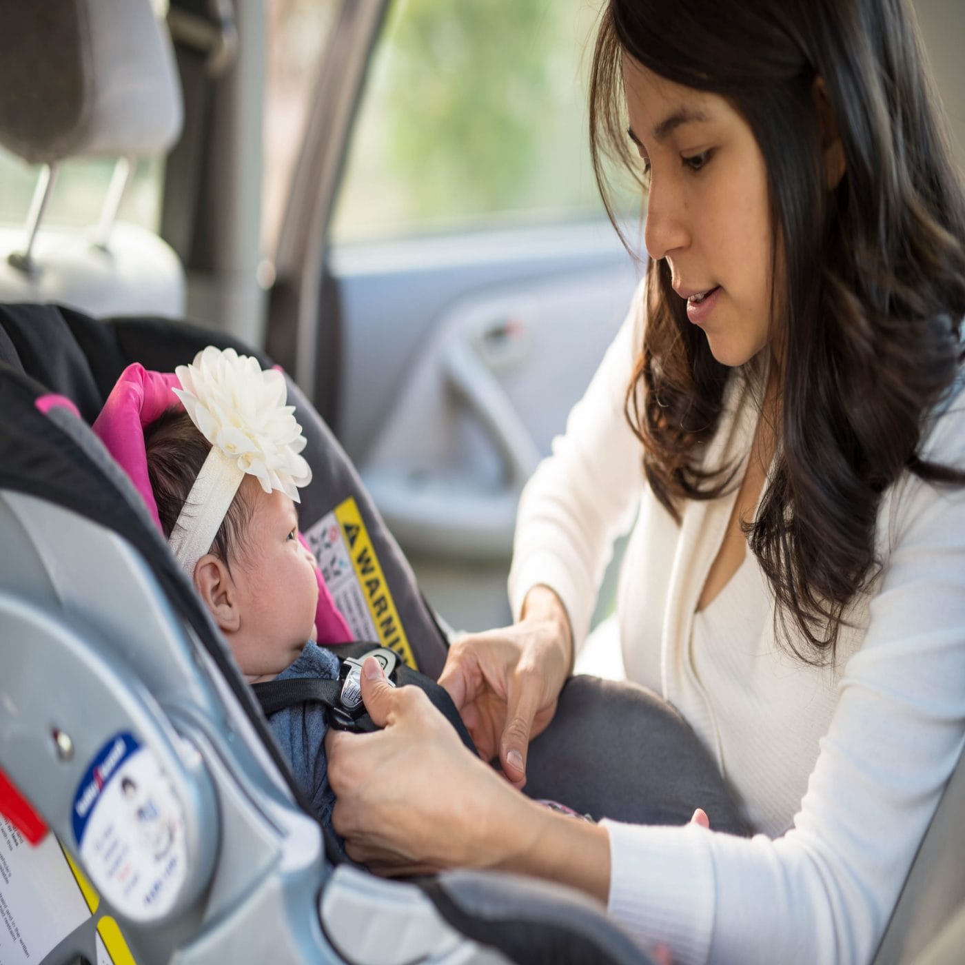 The surprising factor that makes car seats less safe mom putting baby in car seat - are car seat accessories safe