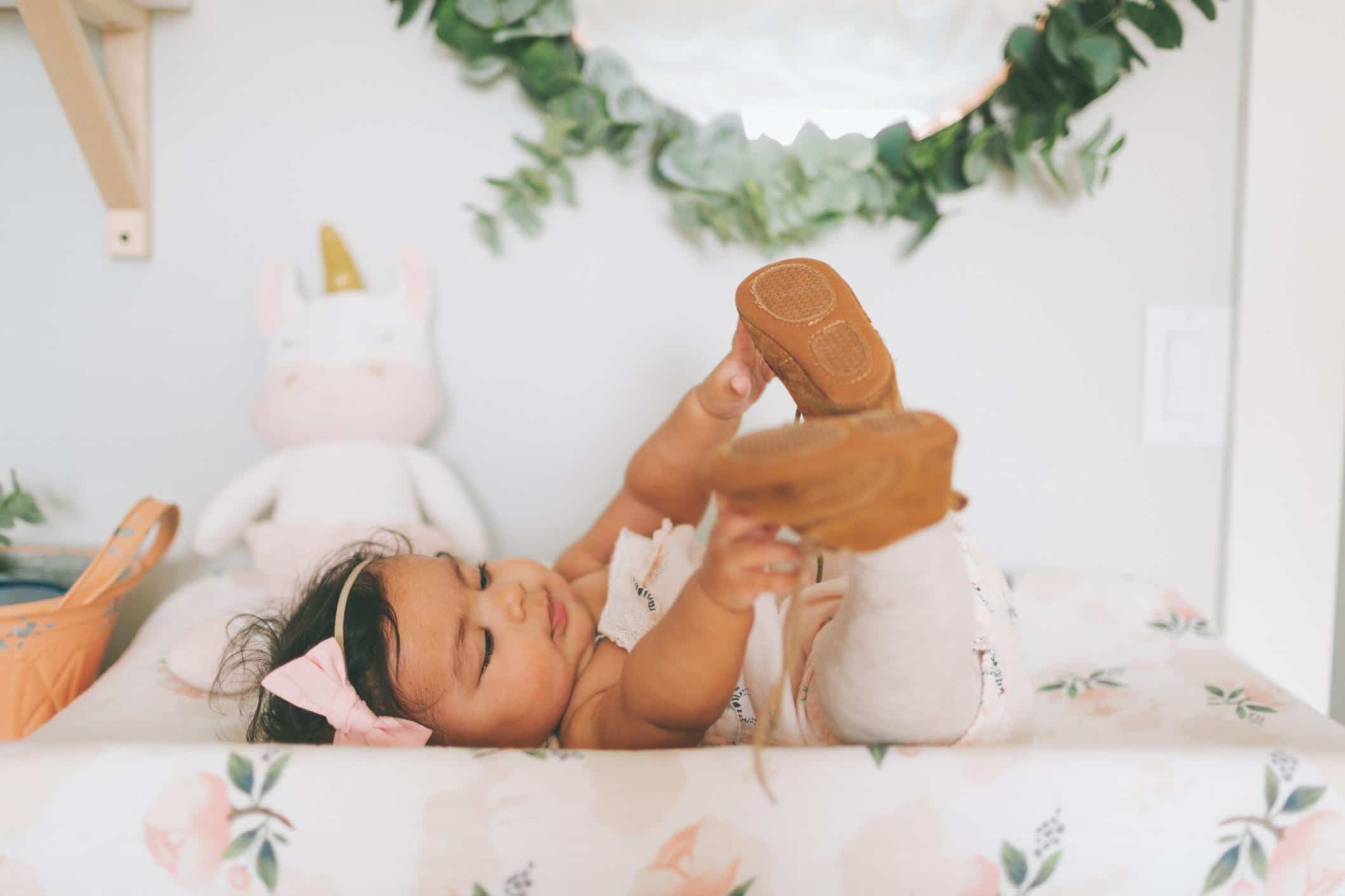 60+ Virgo zodiac baby names for August & September babies little girl reaching for her toes- virgo baby names