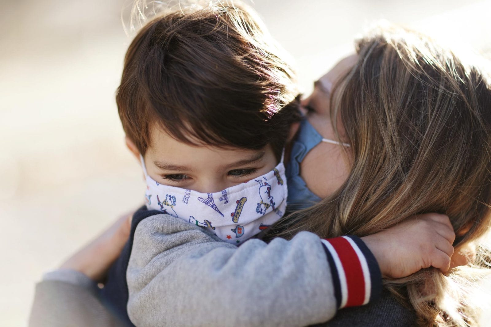 To the mama sending her kids back to preschool—your little ones are going to be OK mom and son wearing masks and hugging
