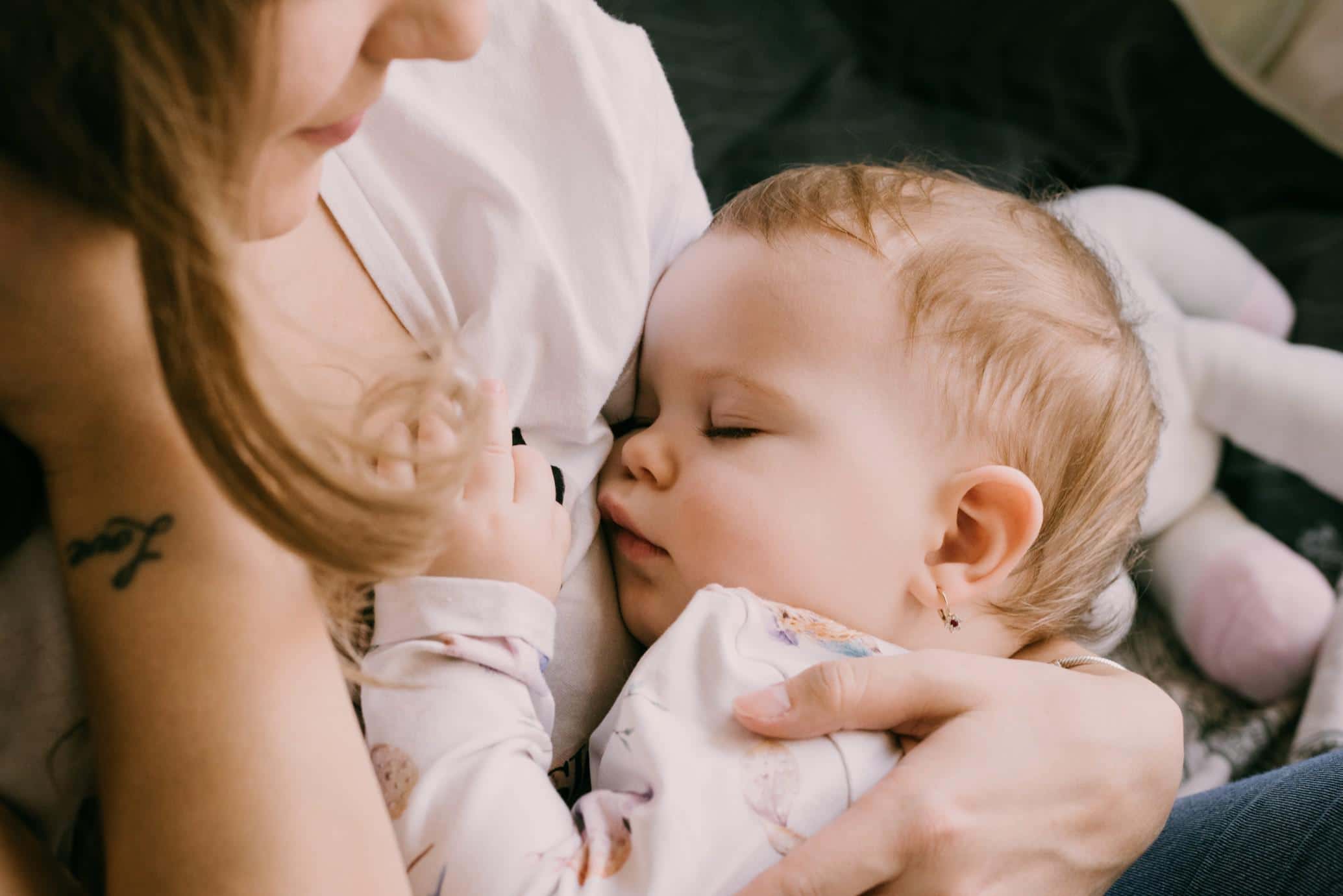 How to stop breastfeeding—while keeping yourself and your baby happy mom holding sleeping baby