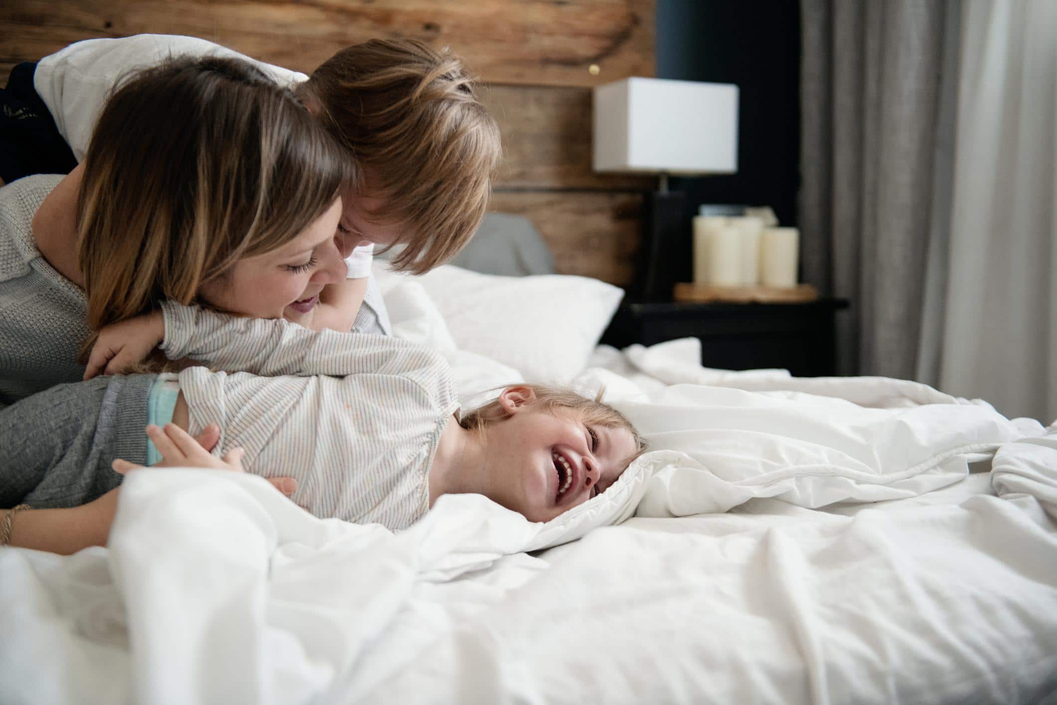 The life-changing benefits of doing ‘nothing’ with your children mom hugging toddler in bed