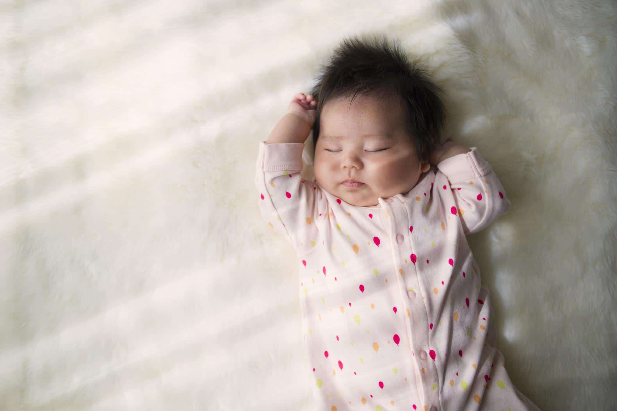 How much sleep does a four-week-old baby need? four-week-old baby sleeping in the sun from a window