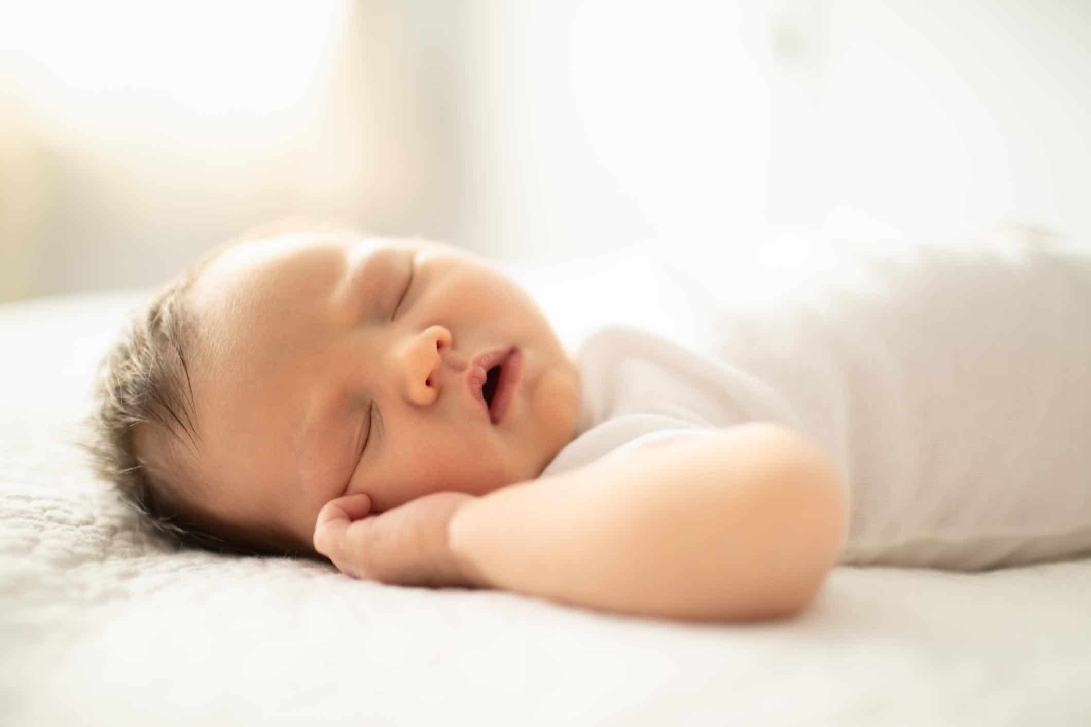 How much sleep does a five-week-old baby need? five-week-old baby sleeping on its back