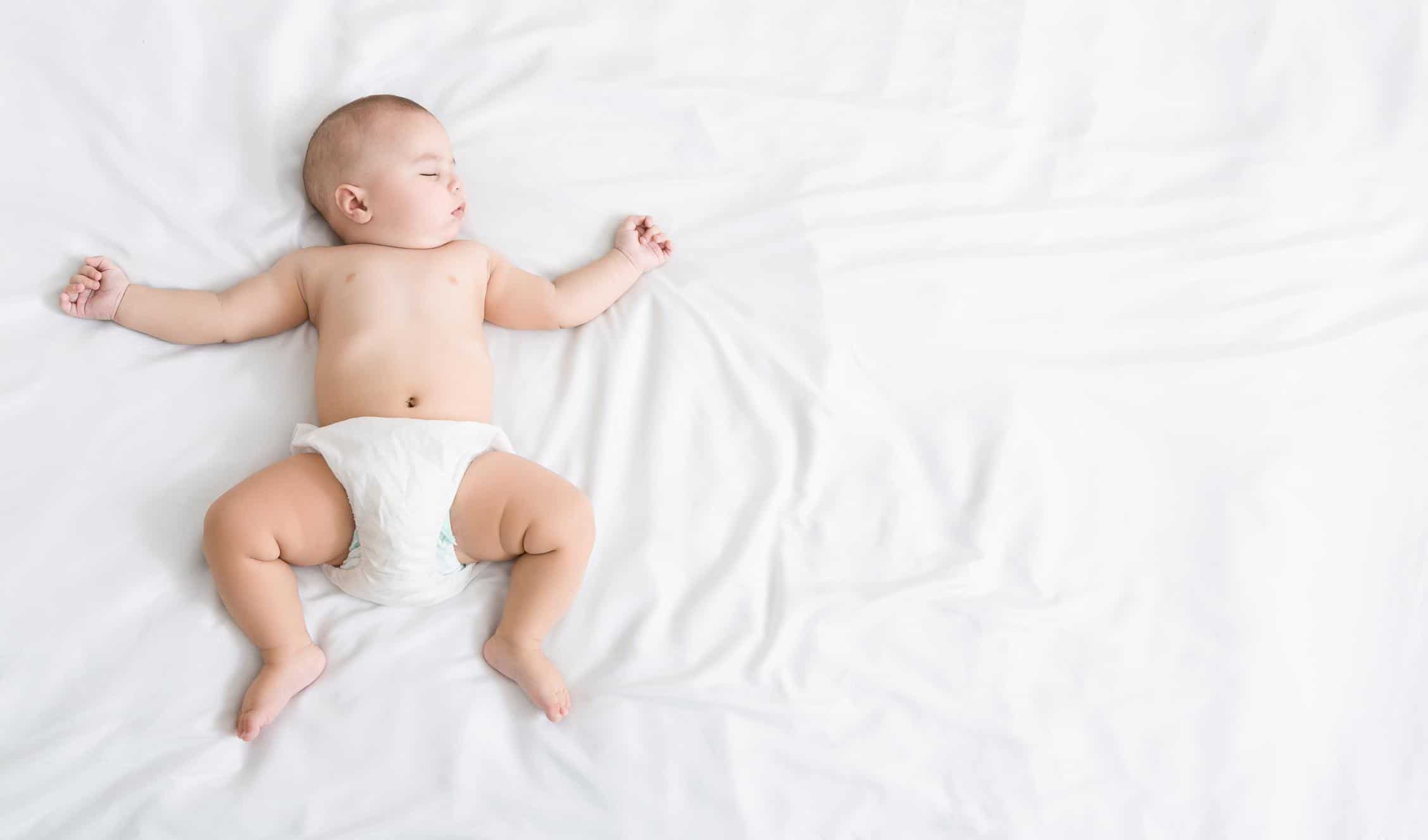How much sleep does a 13-week-old baby need? 13-week-old baby sleeping on a bed