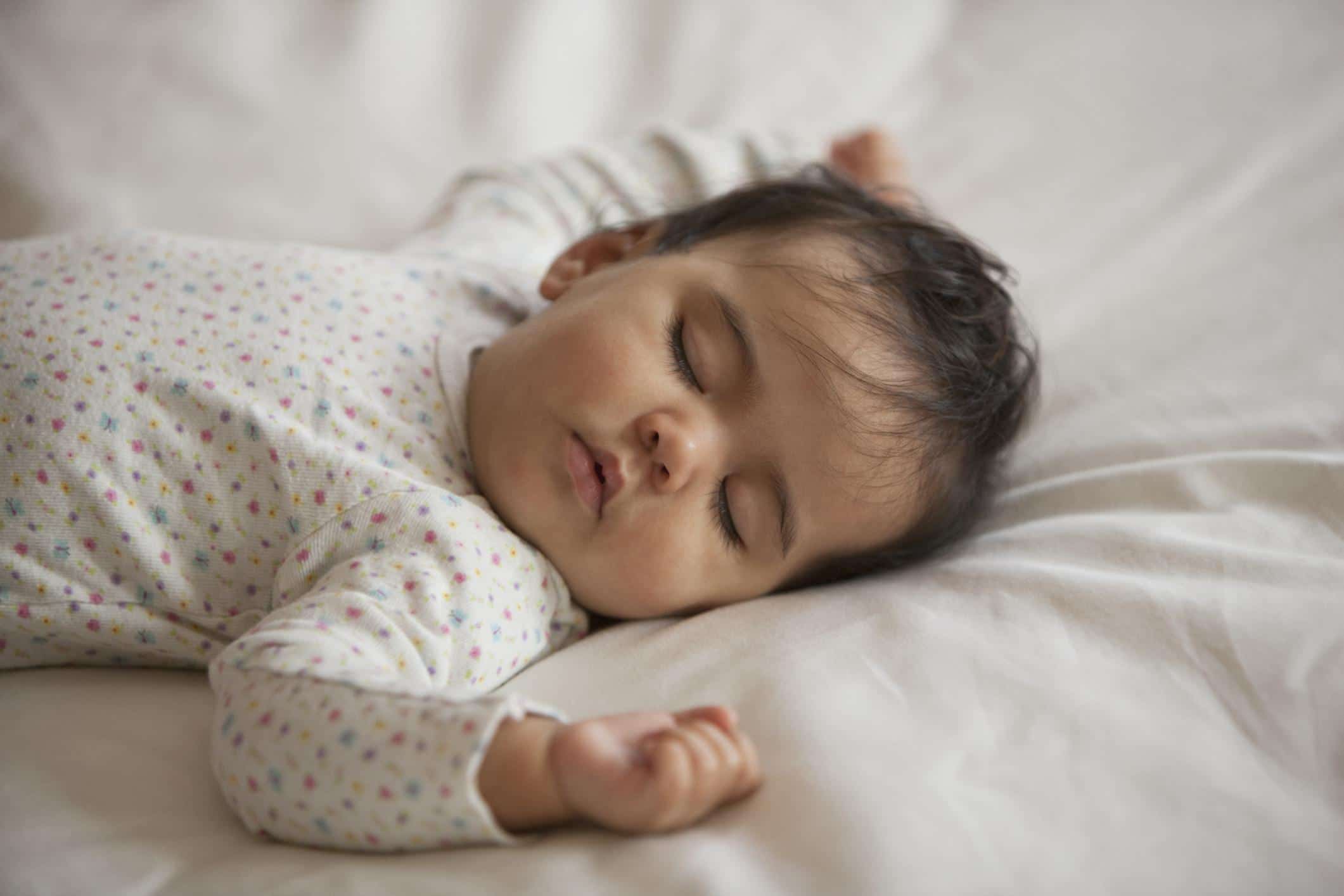How much sleep does a 10-week-old baby need? 10-month-old baby sleeping on a bed