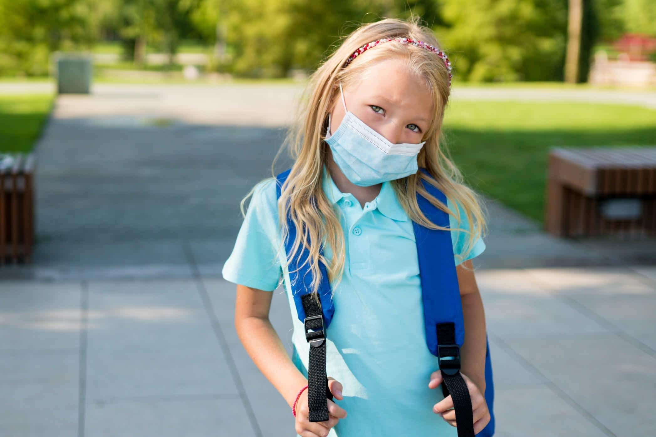 Everything we know about the Delta variant and kids child wearing a mask at school