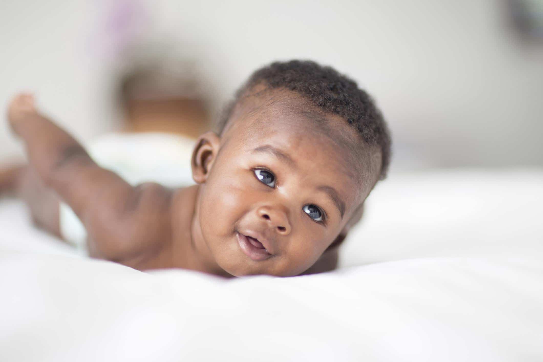 24 September baby names for your early-Autumn bundle baby boy doing tummy time- September baby names