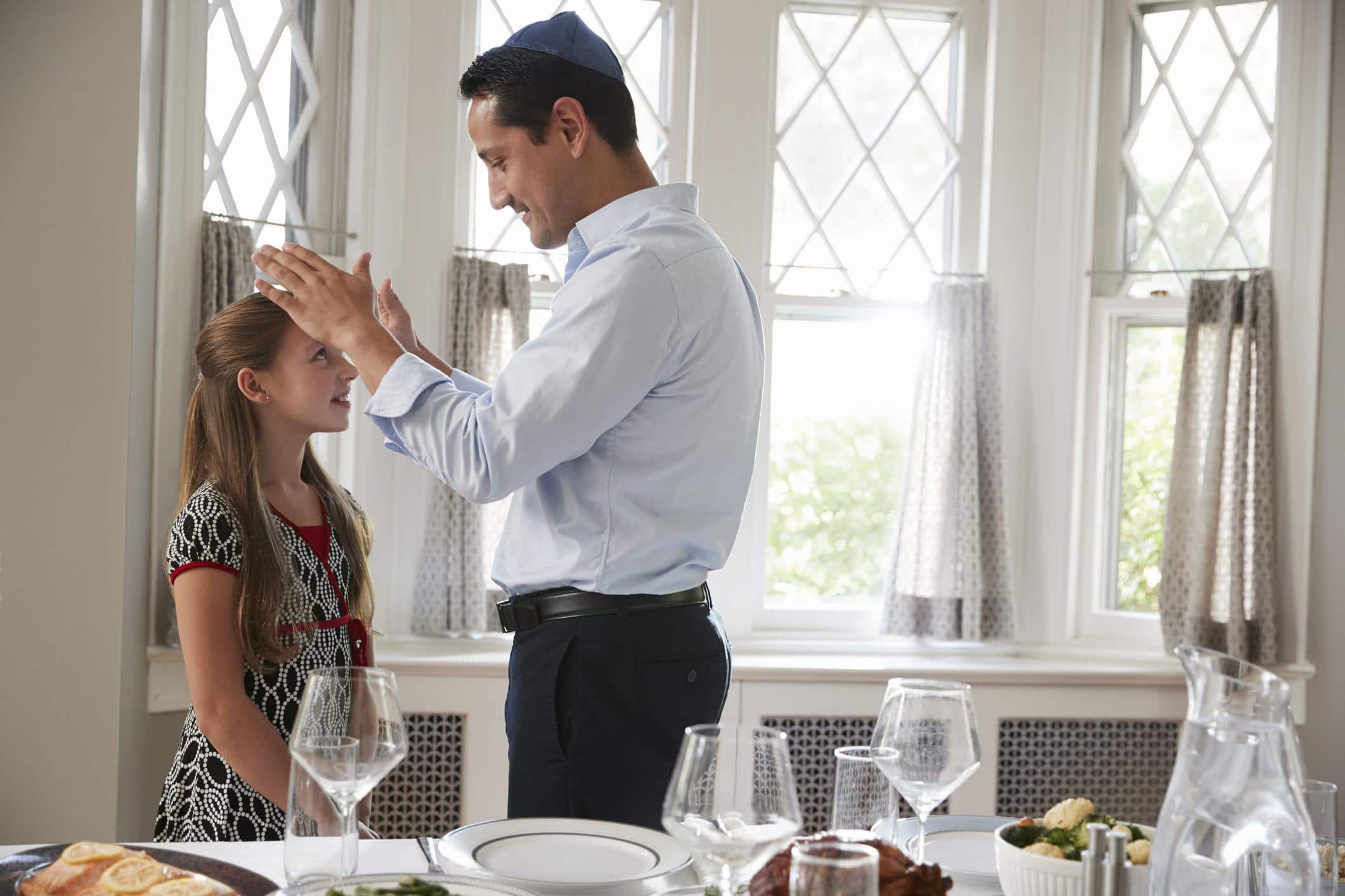 How to talk to your kids about Jewish history and culture father blessing daughter with his hands - how to teach kids about jewish history
