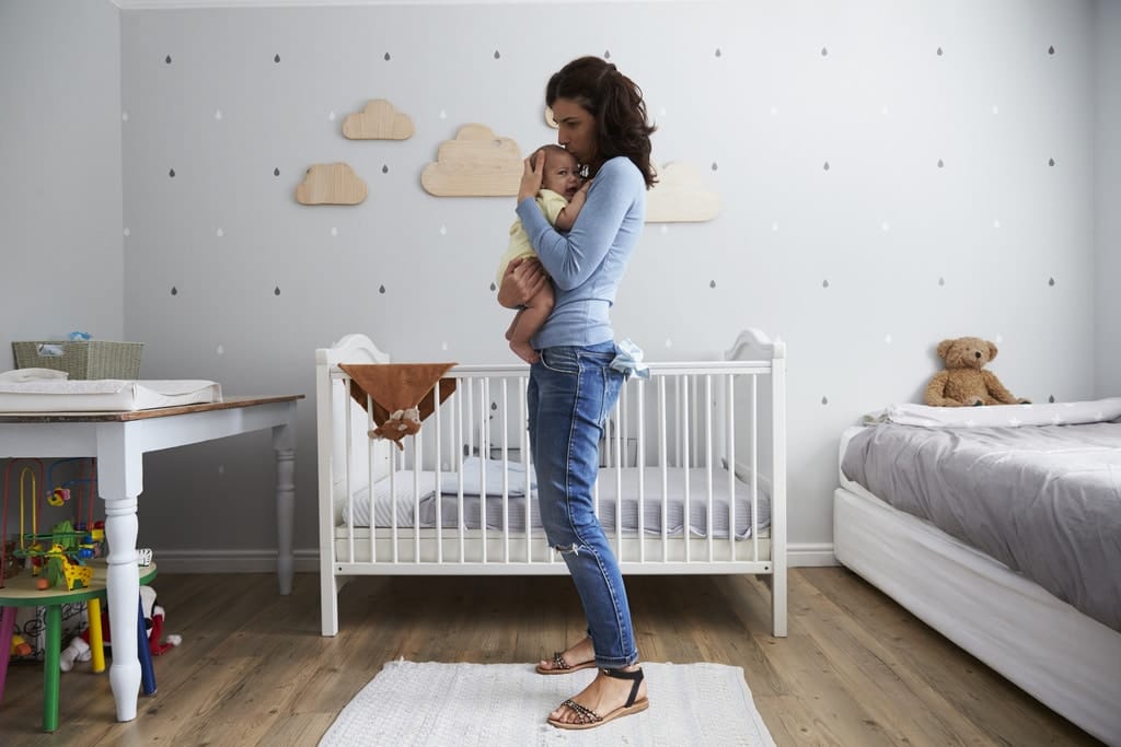 If SAHMs were paid, their salary would be $184K/year mom holding baby outside of her crib- sahm