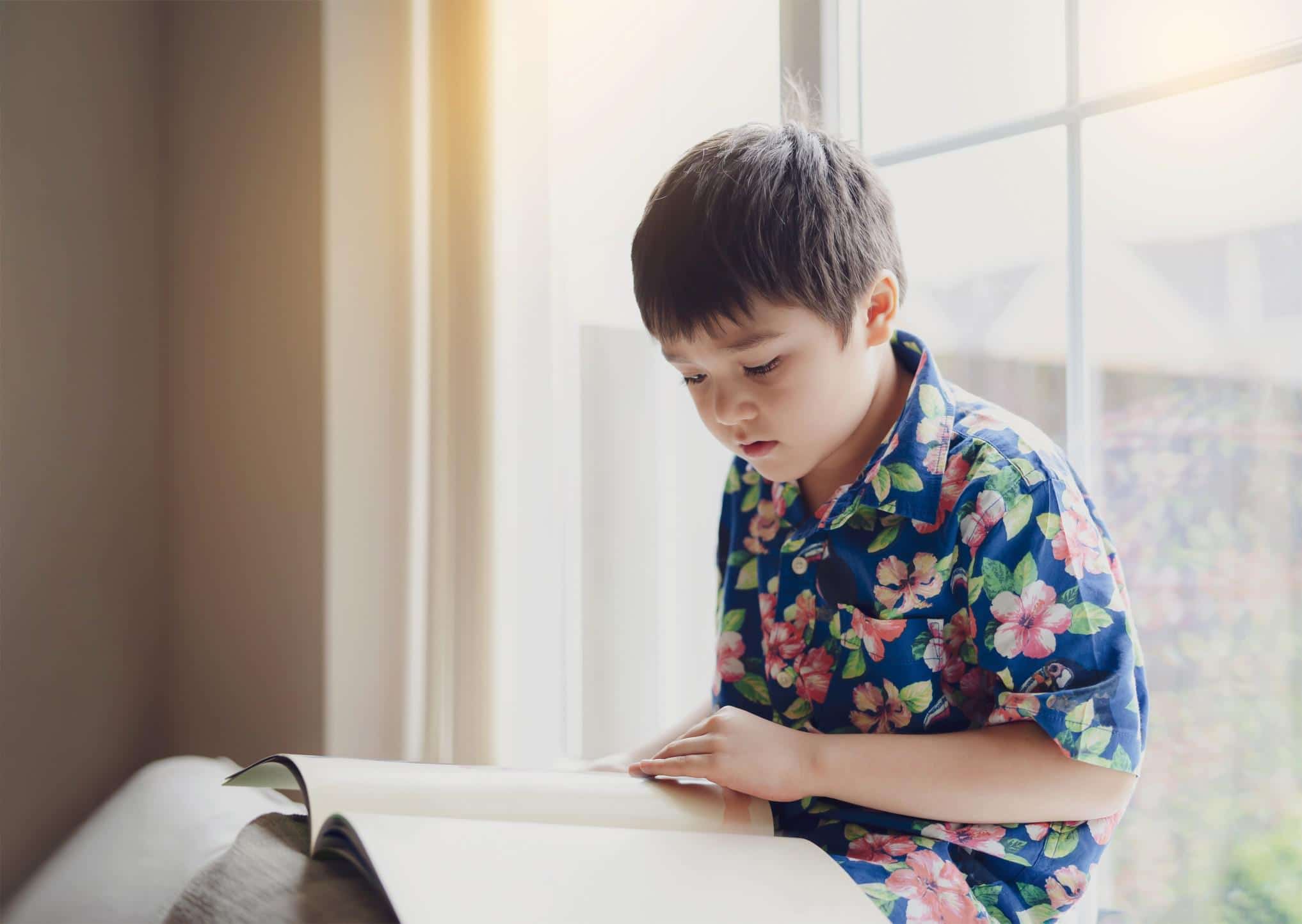 How to talk to your kids about Indigenous history and issues little boy reading - indigenous peoples history