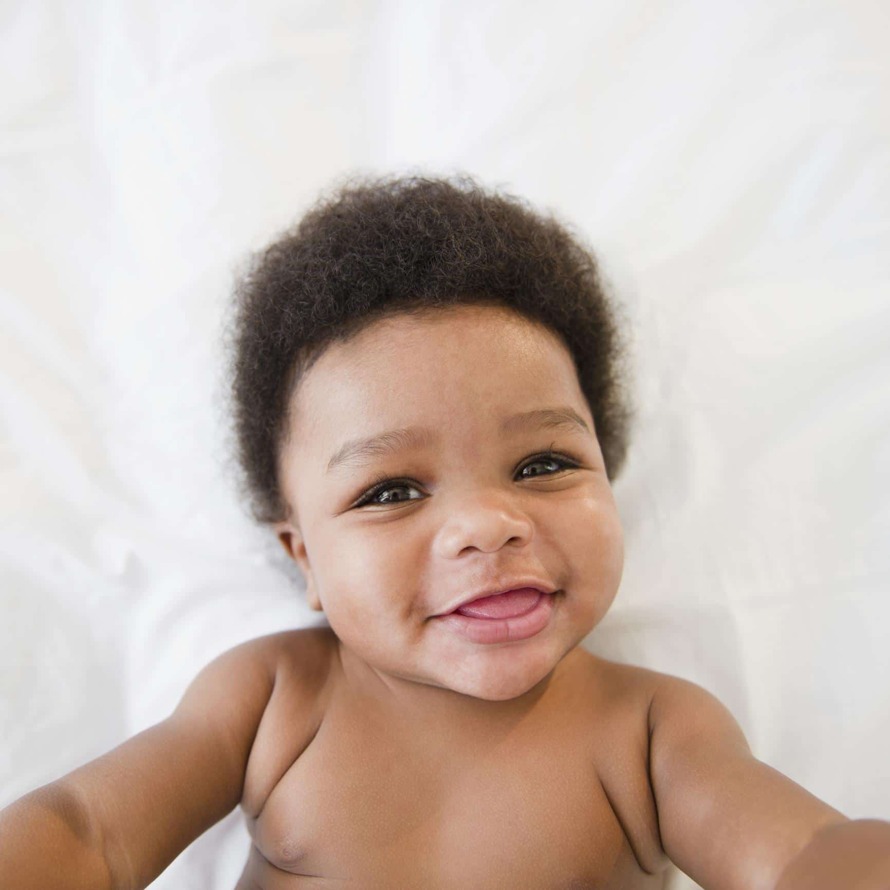 75 Scorpio-inspired baby names for those born in October & November baby smiling at camera - scorpio baby names
