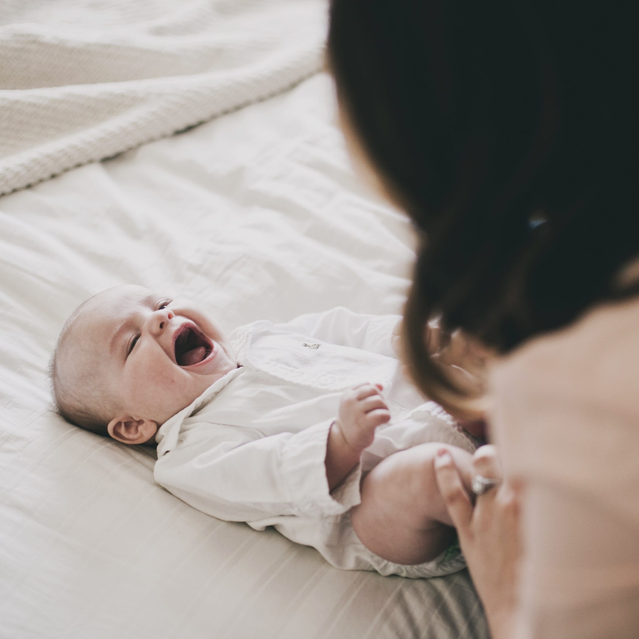 Activities for a 6-month-old: Fostering baby’s development mom playing with smiling baby - activities for 6-month-old