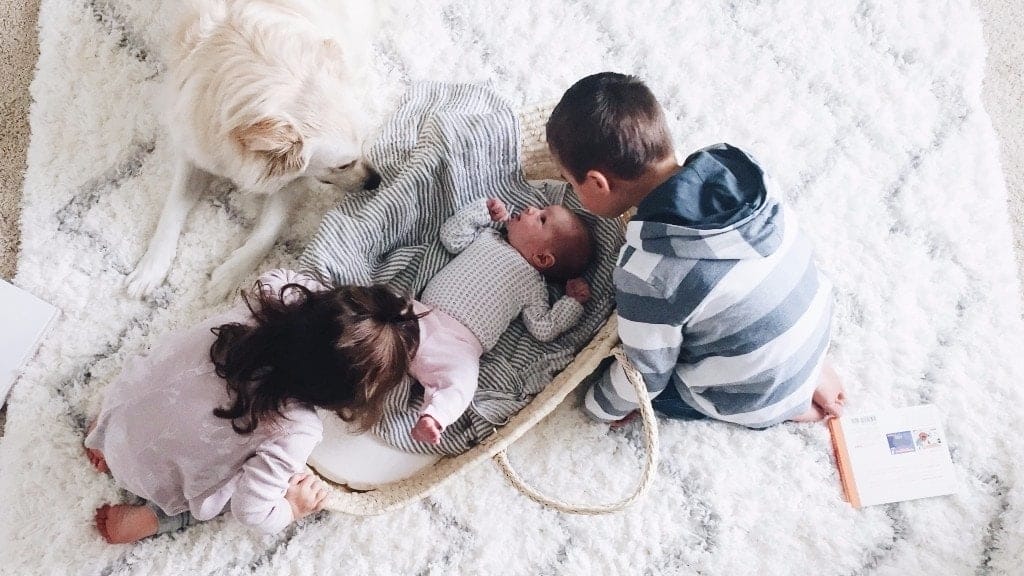 Should we have another baby? The pros and cons of having a third child three children playing on the ground