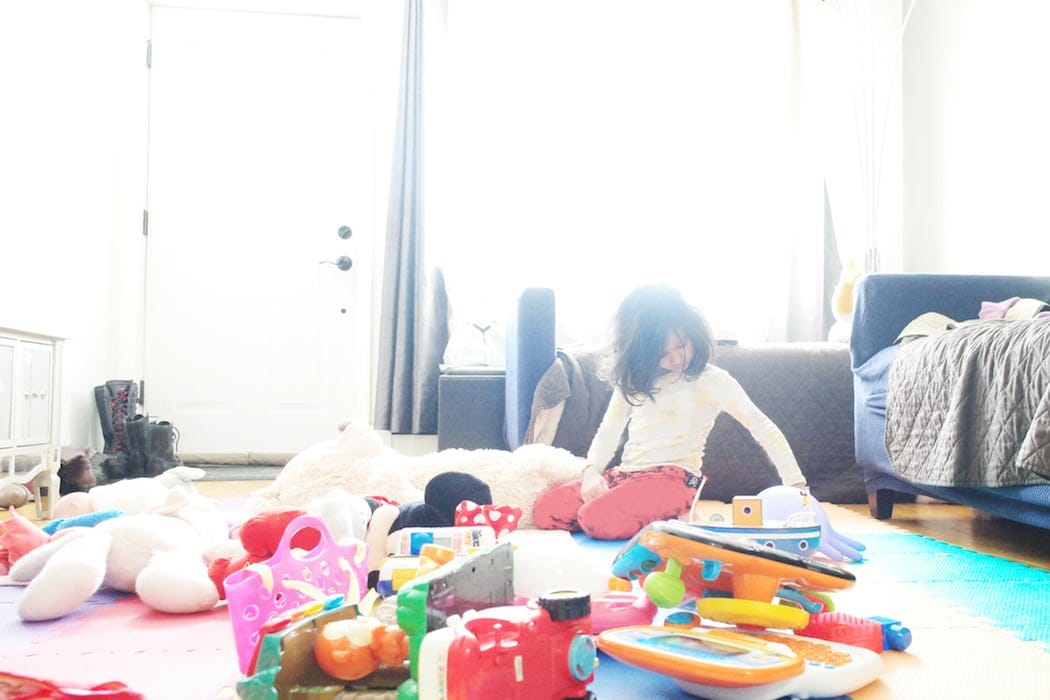 True life: I’m going to stop apologizing for my messy house now child sitting on the living room floor with toys all about- stop apologizing for a messy house
