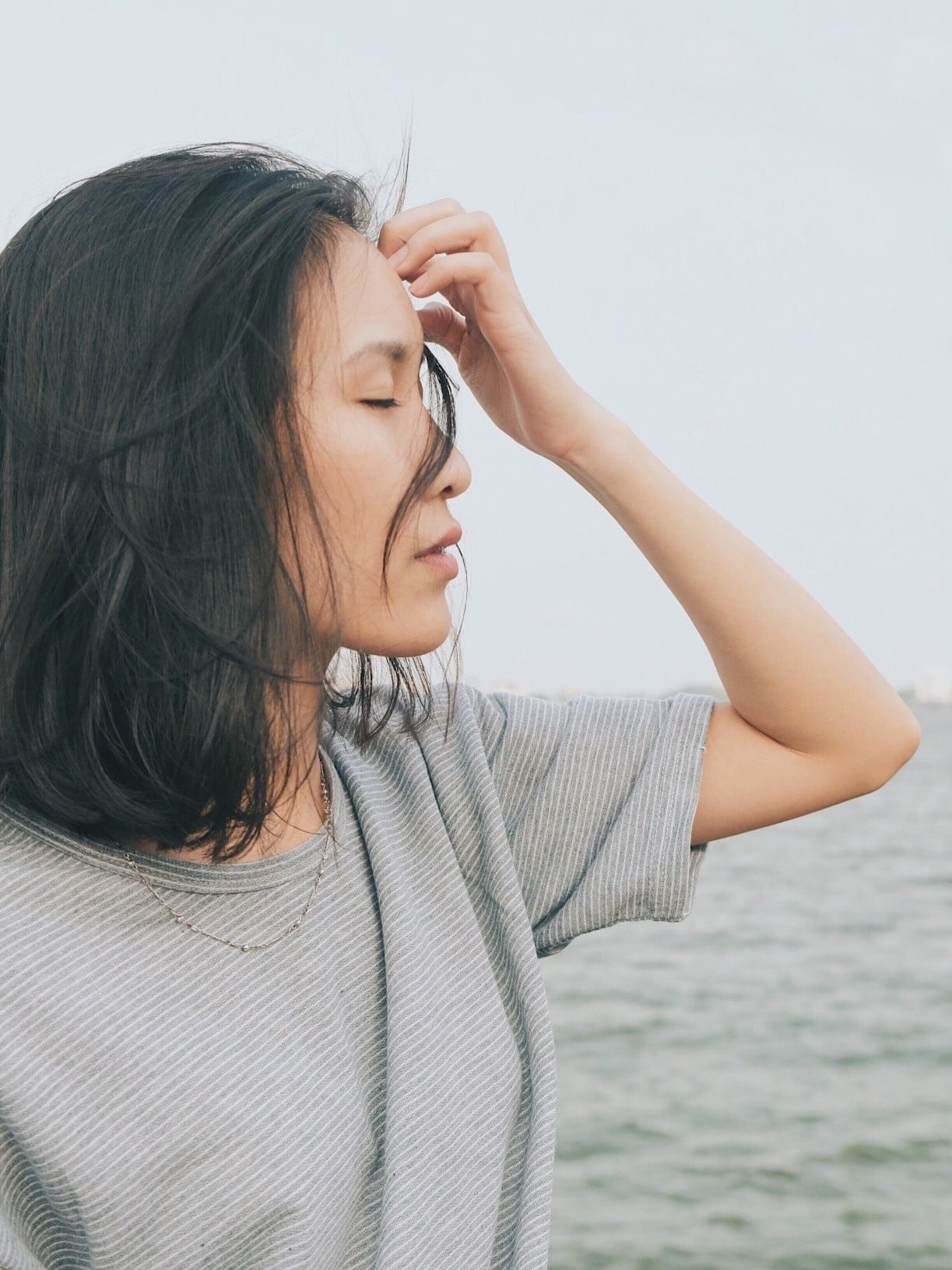 Postpartum depression and anxiety are more common than you may think—here are the resources you need woman getting hair out of her face