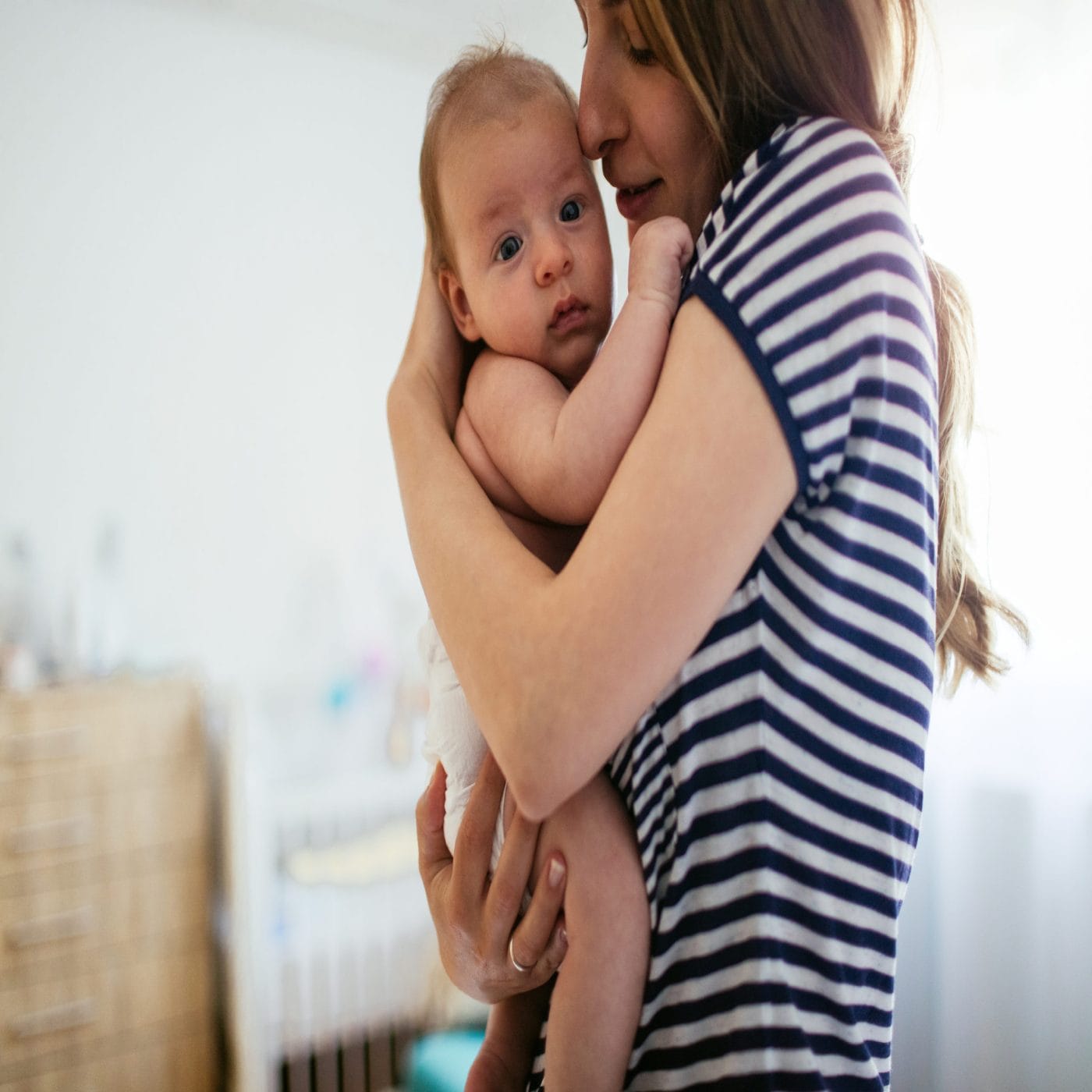 To the mama who is surviving not thriving—it won’t be like this forever mom holding newborn baby