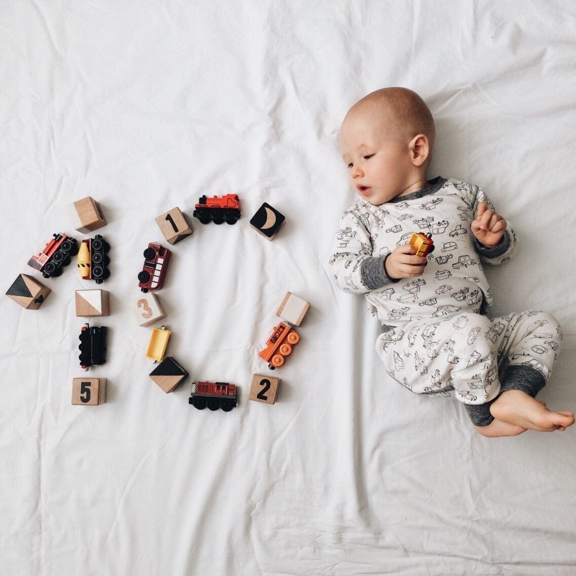 These are the top 200 baby names of the decade baby boy laying next to toys