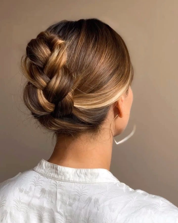 This easy French braid ponytail is about to be your new go-to look back of womans head showing a french braid