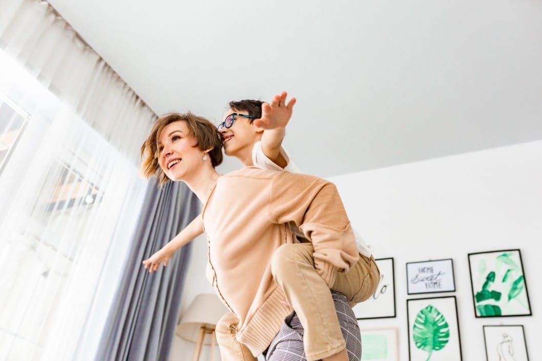 It’s science: *This* is one of the best ways to deal with stress (for you and your kids) mom flying a kid on her back