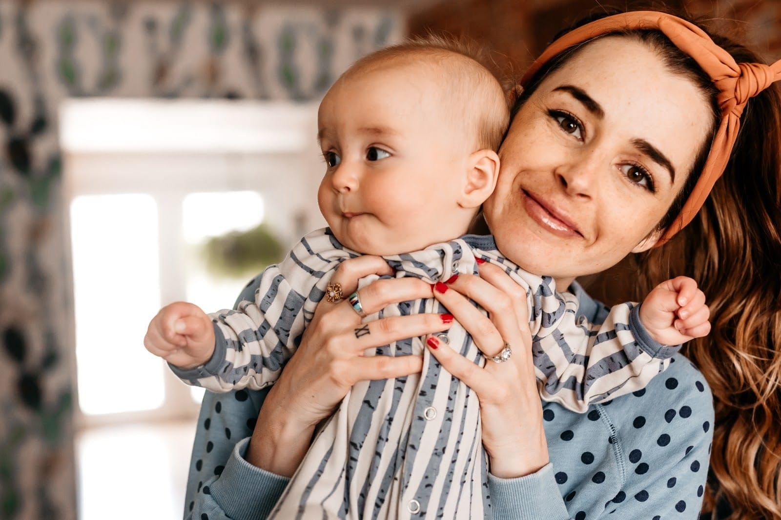 How mindfulness saved my motherhood from anxiety, PPD and OCD woman holding up newborn baby