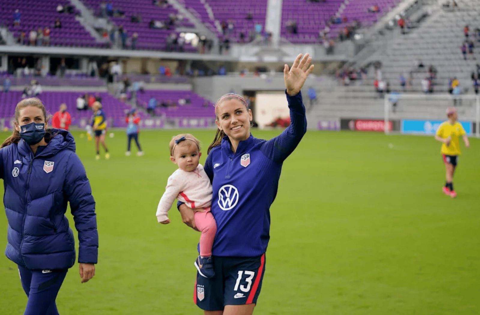 Breastfeeding athletes can now bring babies to the Olympics after moms speak out Olympic soccer athlete holding her baby on the field