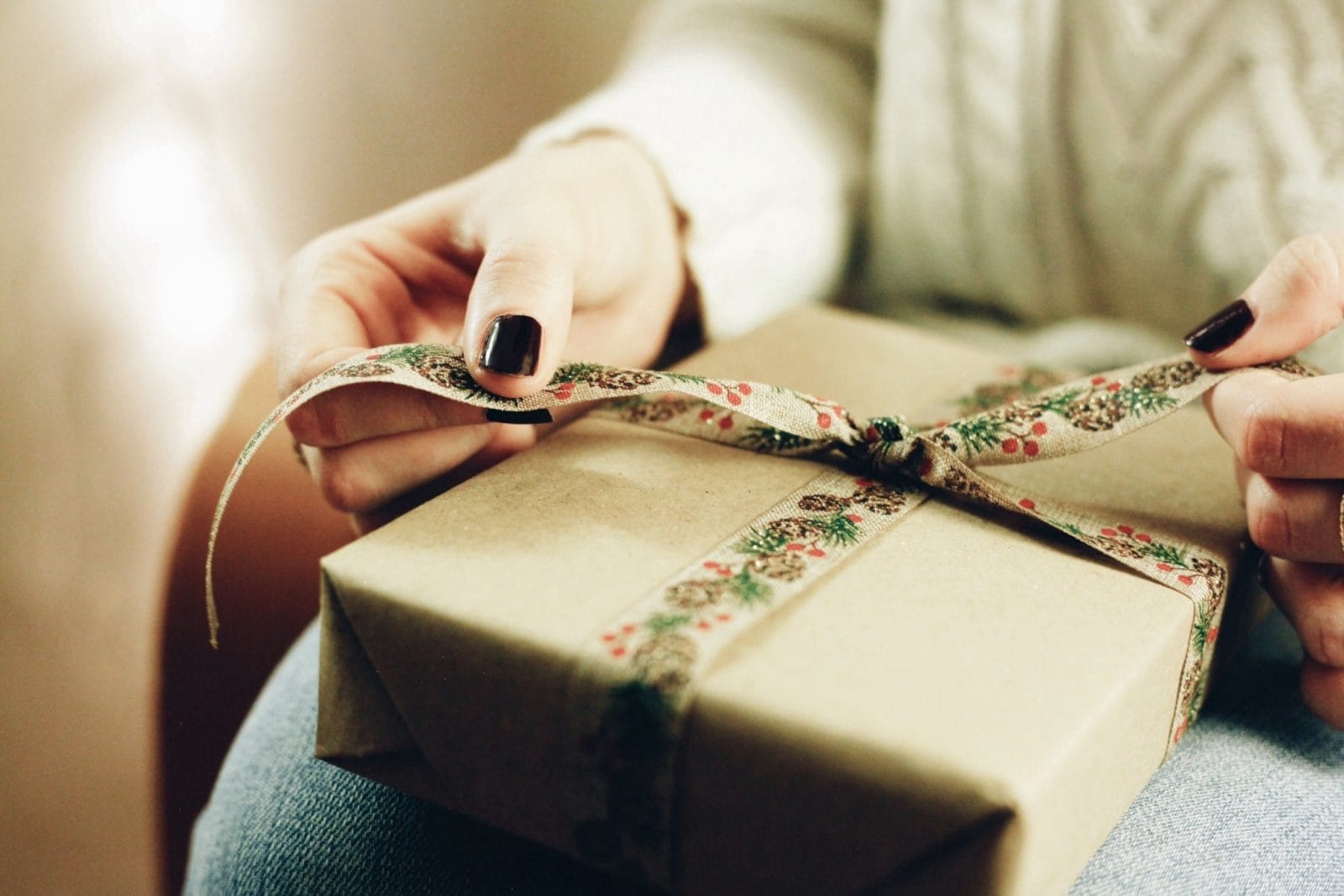 Mama, I see you making Christmas magic while stretching every dollar a person holding a gift box