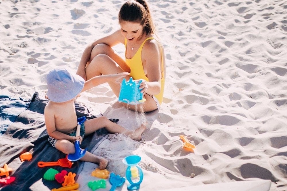 It’s science: Vacations make your kids happy long after they’re over mom and son playing with sand on the beach, thinking about the psychological benefits of family vacations