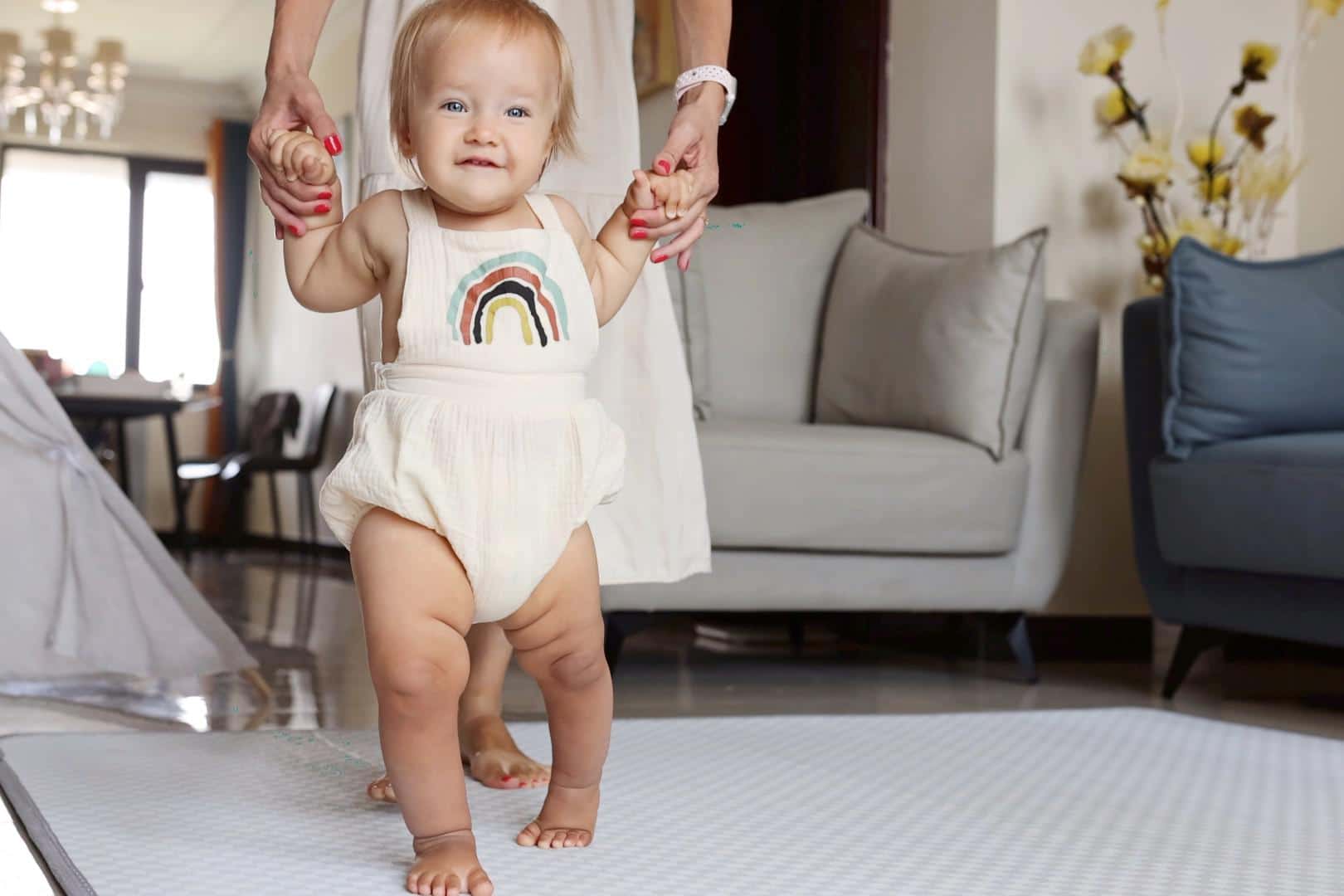 12-month-old baby milestones baby walking with help, one of the more common 12-month milestones
