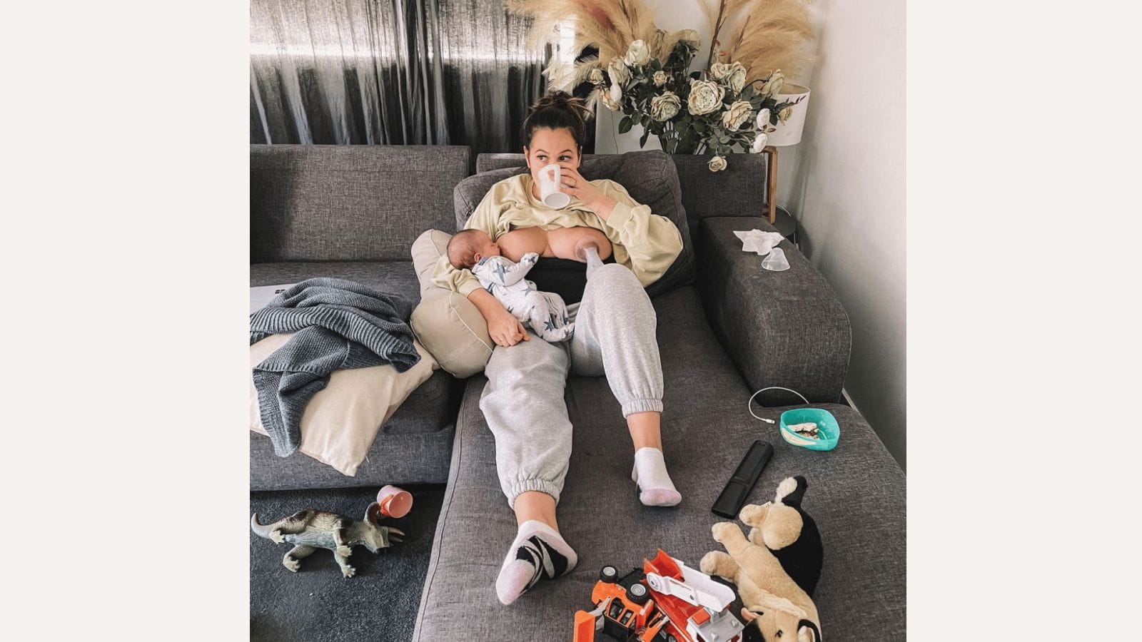 This mama nails ALL the emotions of the newborn bubble mom holding a baby on the couch drinking coffee