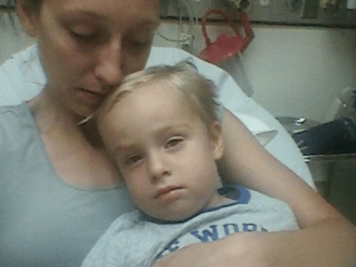 mom holding her son in a hospital bed