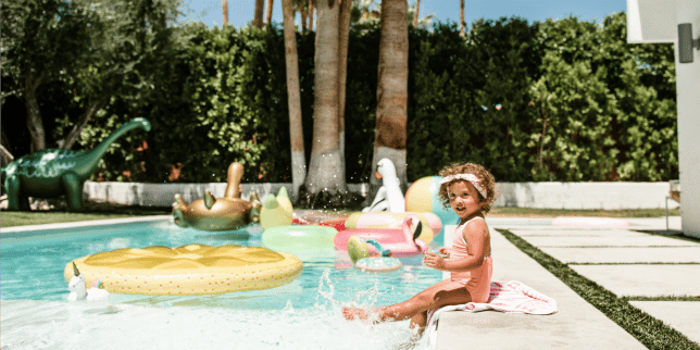 Summer Baby Fashion child sitting on the edge of a pool