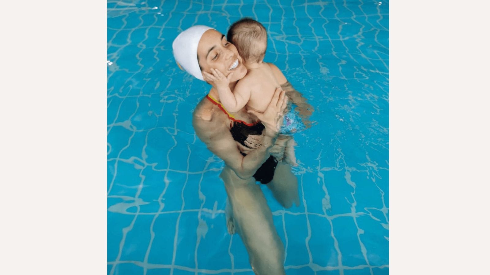 Swimmer calls out Olympics for ‘drastic’ breastfeeding rules Olympic swimmer holding son in the pool