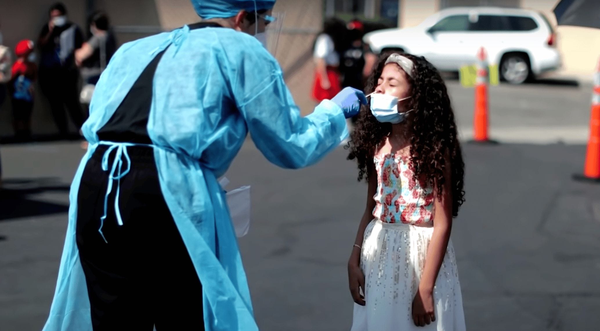 Children are now being hospitalized for COVID in record numbers doctor doing a COVID test on a little girl