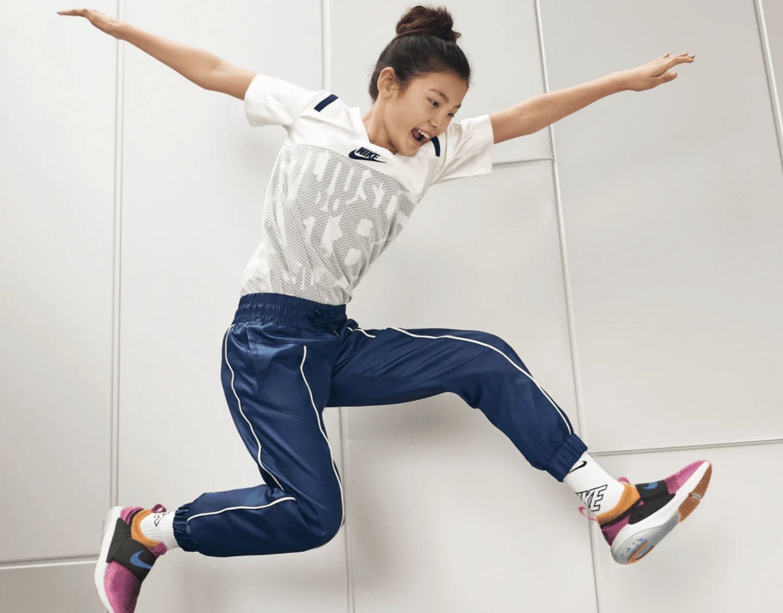 These challenges from Nike PLAYlist are exactly what my child needs to stay active girl jumping in the air