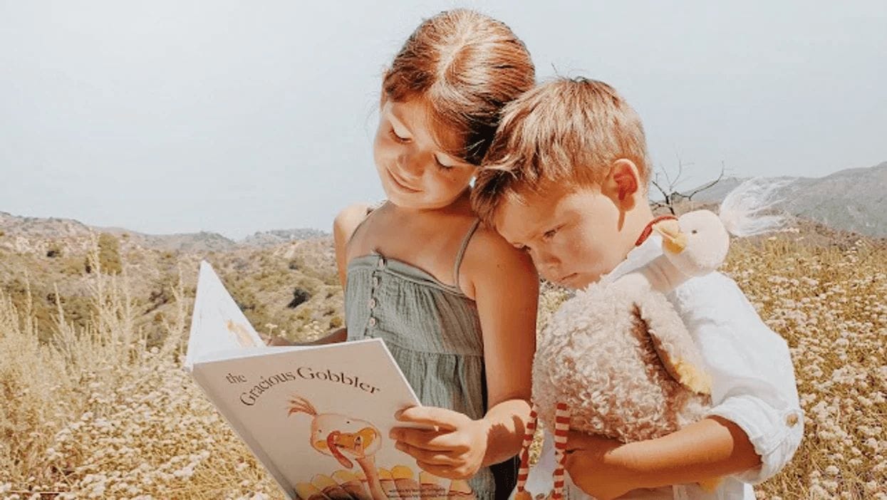 Meet the Gracious Gobbler: A simple November tradition that teaches kids gratitude two-kids-reading-a-book-together