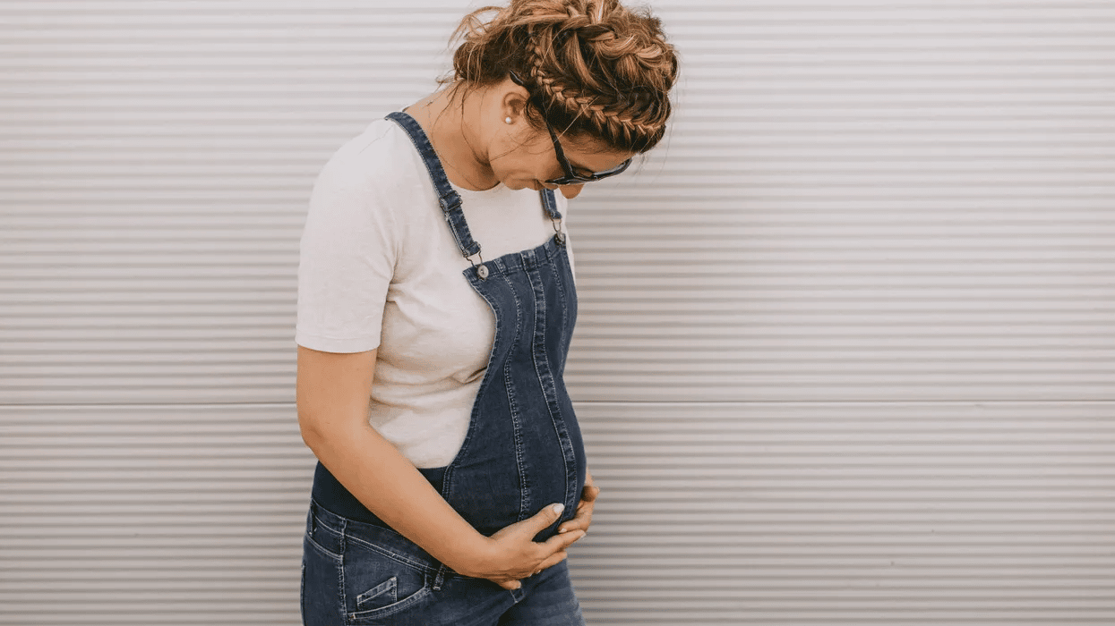 9 essential questions to ask during your first prenatal visit prenatal visit: pregnant woman holding her belly