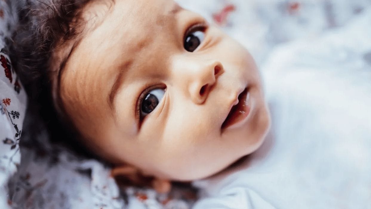 What to do when your toddler needs a nap but won’t take one baby looking at the camera
