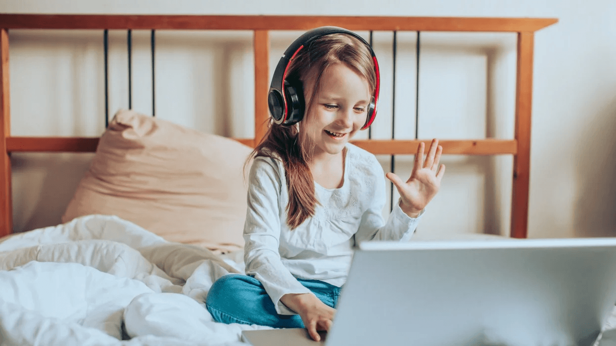 child-waving-hi-to-computer-screen