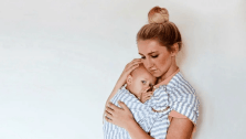 The science behind why your baby stops crying when you stand up Mom and baby in wrap carrier