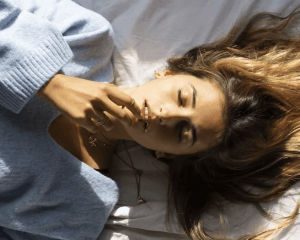 woman lying down in bed - Motherly