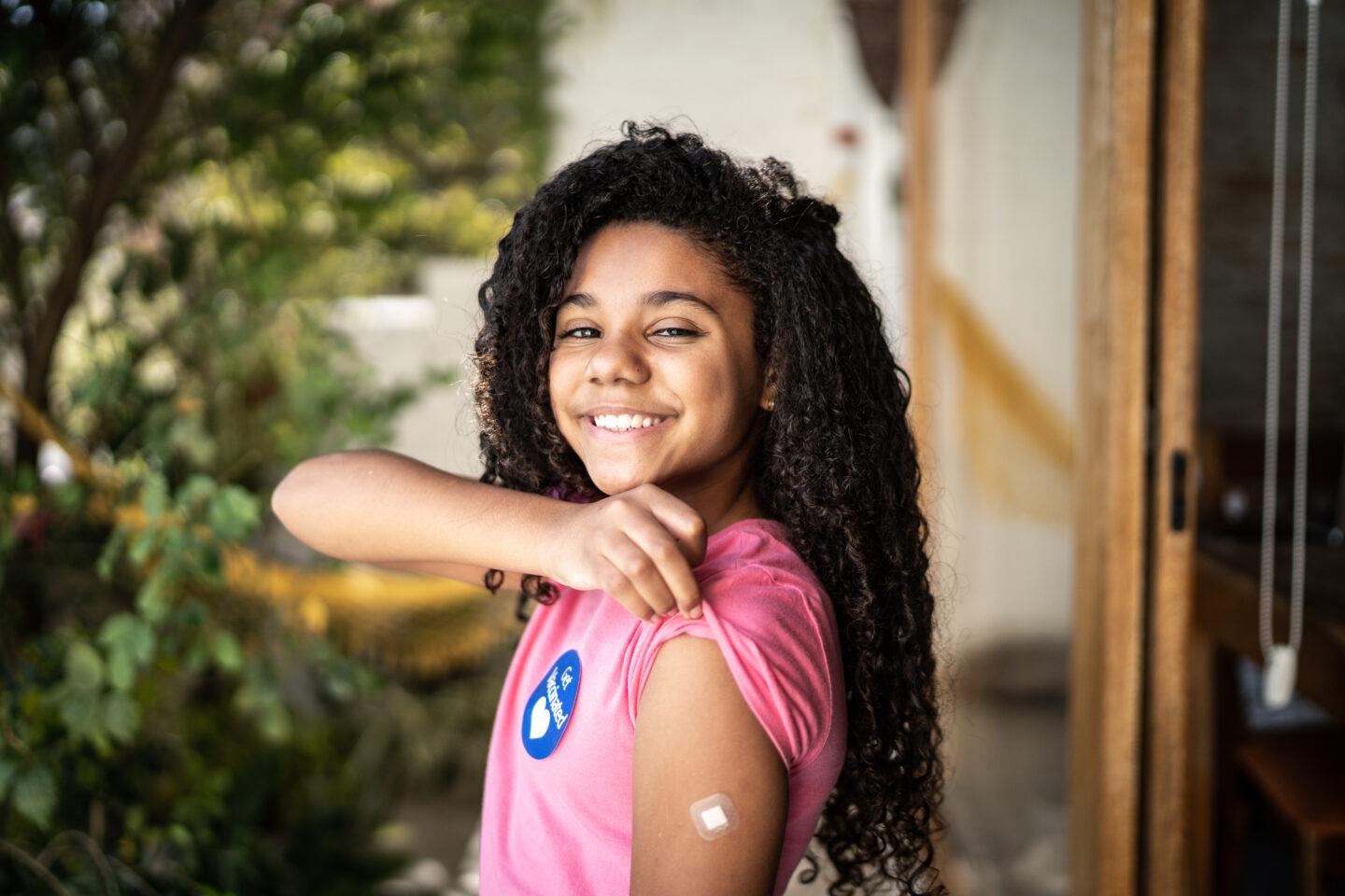 More than 1.5 million kids have received their first Covid vaccine Portrait of girl showing ar after vaccination