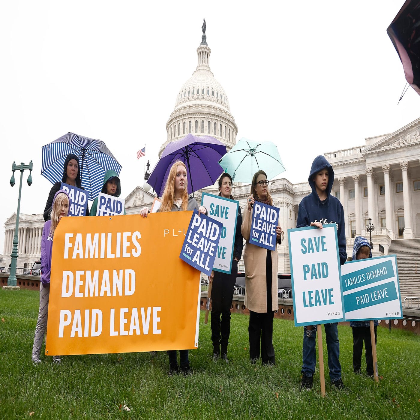 Paid leave has been added back into major social spending bill women-holding-signs-in-front-of-captial-building-about-paid-leave