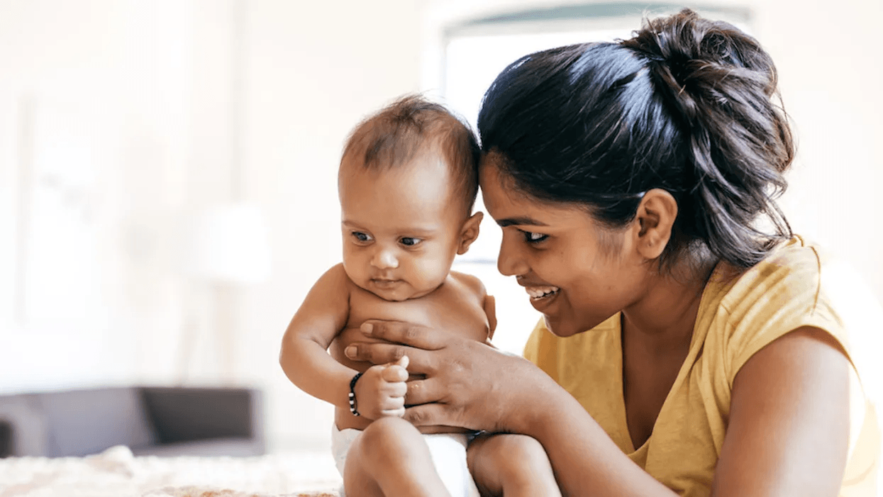 After going back to work, I now cherish ‘boring’ days with my baby mom holding new baby