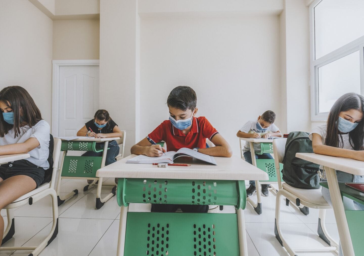Covid testing in schools can replace quarantine, CDC says Children studying in class with face mask during pandemic