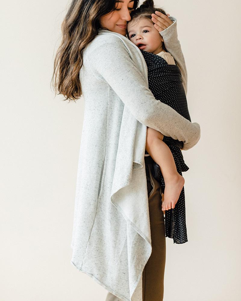 Ready to start a capsule wardrobe? These versatile pieces help ‘minimalism’ go farther Mom holding baby in front carrier
