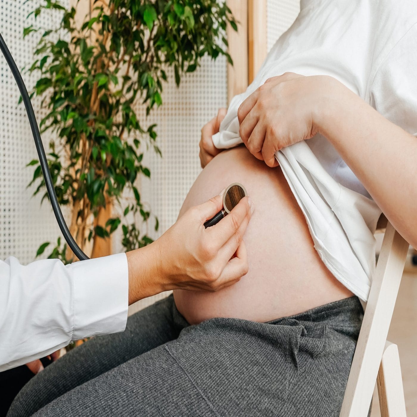 Your guide to finding a birth provider who’s LGBTQ-friendly pregnant person at doctor's office getting pregnancy checkup - lgbtq birth provider