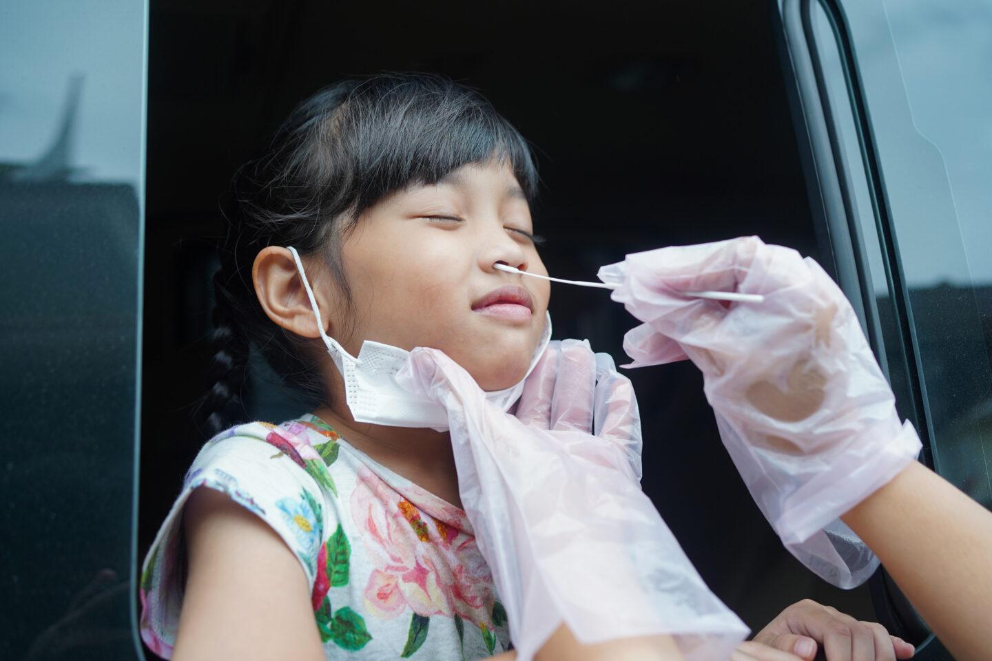 Covid infection linked to an increased risk of diabetes in kids, says CDC covid and diabetes in kids: young girl having covid PCR test done through car window