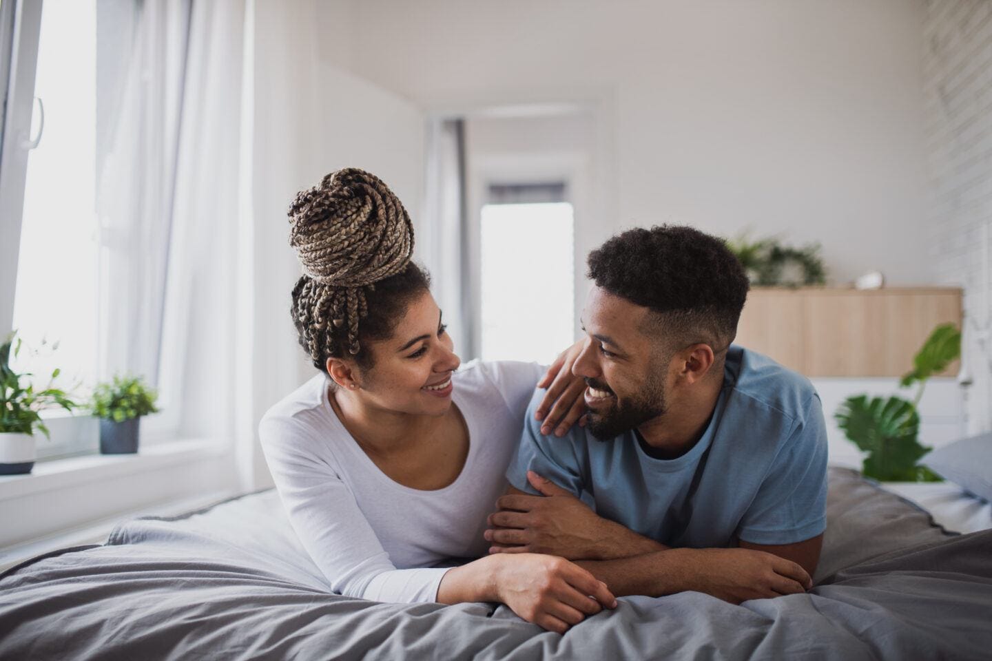 These are the actual chances of getting pregnant each month chances of getting pregnant: couple looking at each other while lying in bed