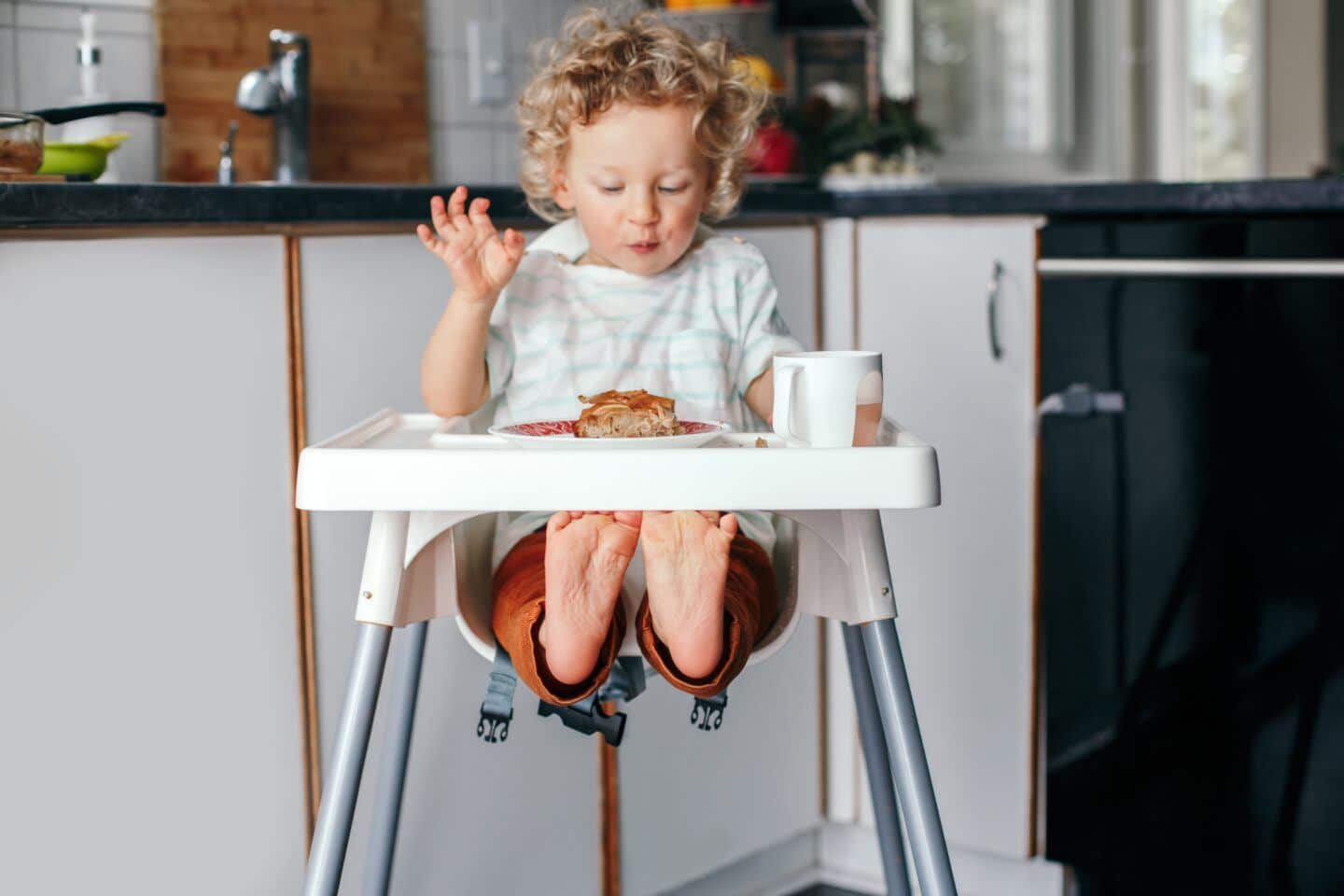 Confession: I’m a dietitian and feeding my daughter is a struggle picky eater: toddler sitting in high chair looking at plate of food