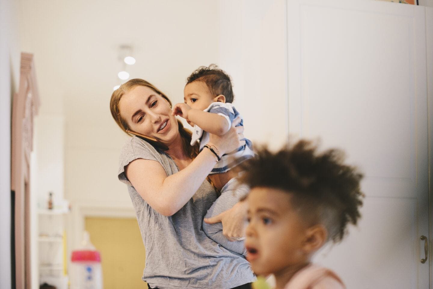Are you touched out, mama? A psychologist shares the signs Touched out: Mother carrying son while attending to toddler